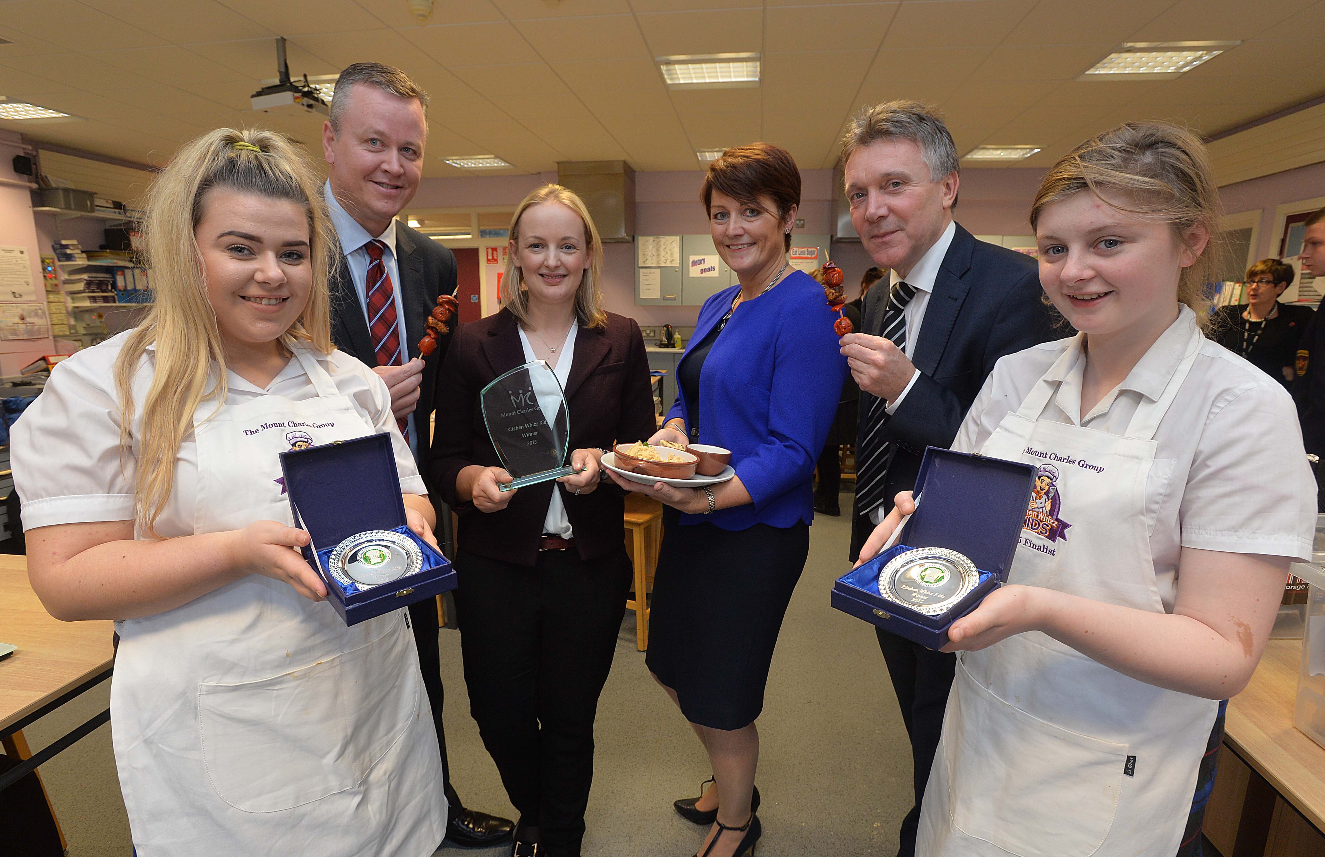 A team from St Genevieve’s High School, Belfast has won the fourth annual Kitchen Whizz Kids cookery competition, beating stiff competition from seven other schools in Northern Ireland. Pictured L-R: St Genevieve’s High School pupil Bronagh McHeading, 15, Cathal Geoghegan, Managing Director of the Mount Charles Group, Fionnaula McAllister, Home Economics teacher at St Genevieve’s, Caitriona Lennox, Operations Manager of Contract Catering Services at the Mount Charles Group, Kieran Heading, Managing Director of Business in the Community and St Genevieve’s pupil Demi-Louise Maguire, 15. Kitchen Whizz kids is organised by the Mount Charles Group, one of Ireland’s largest business support services organisations, and is supported by Business in the Community. The highly competitive cooking competition aims to promote healthy eating and generate interest in the catering industry.